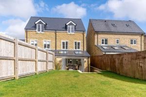 a large house with a fence in front of it at Burbage View in Buxton