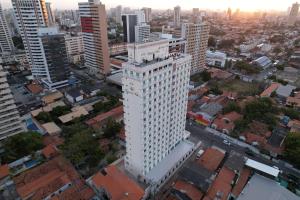 an overhead view of a tall white building in a city at Hotel da Villa in Fortaleza