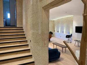 a staircase in a building with a stone wall at Superbe appartement avec vue in Arles