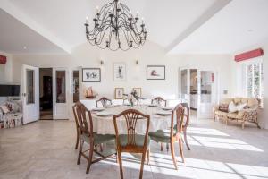 a kitchen and dining room with a table and chairs at The Stable Cottage in Watlington