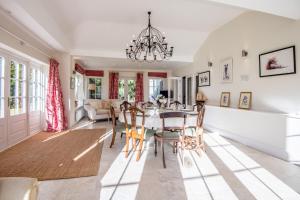 a dining room and living room with a table and chairs at The Stable Cottage in Watlington