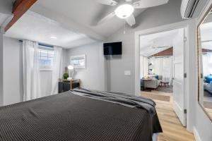 a bedroom with a bed and a ceiling fan at Courtyard Flat - City Center Walk to Everything in Saint Augustine