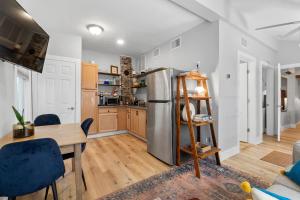 a kitchen with a stainless steel refrigerator and a table at Courtyard Flat - City Center Walk to Everything in Saint Augustine