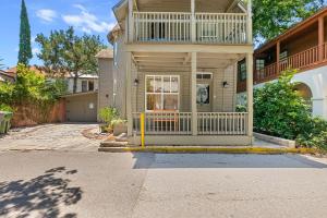 a house with a balcony on the front of it at Courtyard Flat - City Center Walk to Everything in St. Augustine