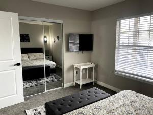 a bedroom with two beds and a mirror at New Remodeled Luxury Condo By The Lake, No Stairs! in Branson