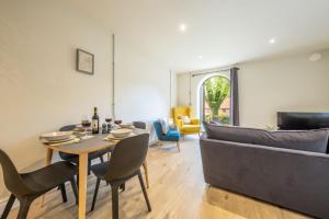 a living room with a table and a couch at 7 Swan Court in Fakenham