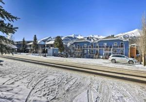 a snow covered street with houses and a car at Main Street Breck, Walk Everywhere! in Breckenridge