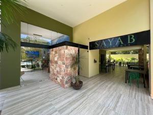 a lobby of a restaurant with a brick fireplace at LOL-HA Hotel Boutique in Cancún