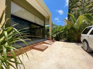 a white car parked in front of a house at LOL-HA Hotel Boutique in Cancún