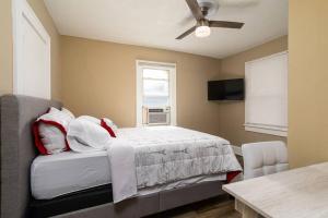 a bedroom with a bed and a window at Spacious Beach Getaway Near Downtown #B in St Petersburg