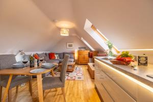 a kitchen and living room with a table and a couch at Cartshed Lodge in Hoveton