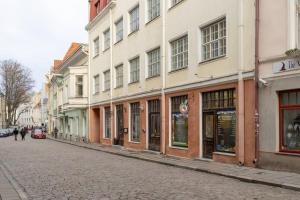 a cobblestone street in a city with buildings at DICTUMFACTUM Luxury Residence in Tallinn