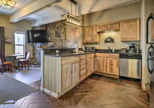 a large kitchen with wooden cabinets and a large island at Main Street Breck, Walk Everywhere! in Breckenridge +23 photos