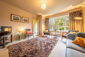 a living room with a couch and a tv at 12 The Close in Brancaster