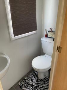 a bathroom with a white toilet and a blackboard at Monks Heath fold mobile home in Macclesfield