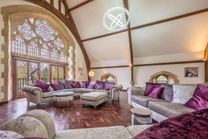 a large living room with couches and purple pillows at The Chapel in North Elmham