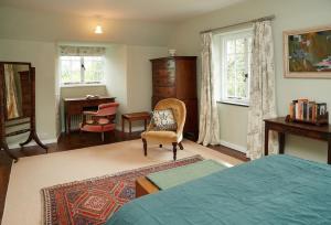 a bedroom with a bed and a desk and a chair at Dolbelidr in St Asaph
