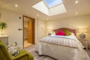 a bedroom with a bed and a skylight at The Gardeners Cottage E 