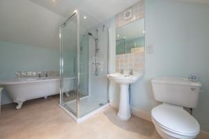 ein Badezimmer mit Dusche, Toilette und Waschbecken in der Unterkunft Daisy Cottage H in Holt + 31 Fotos