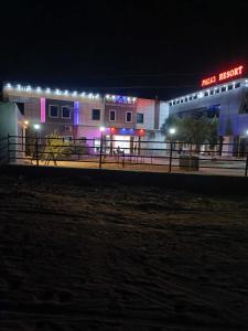 a building with lights in front of it at night at POP 80511J Palki Hotel And Marriage Palace in Singhāna