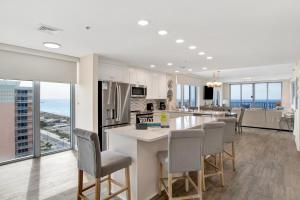a kitchen and living room with a view of the ocean at Emerald Dolphin #1610 in Pensacola Beach