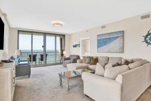 a living room with a couch and a table at Emerald Dolphin #1610 in Pensacola Beach