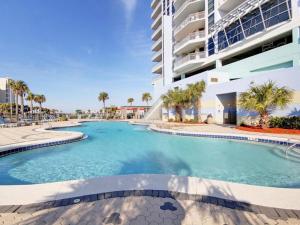 a large swimming pool in front of a building at Emerald Dolphin #1610 in Pensacola Beach