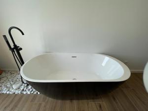 a bath tub sitting on the floor in a bathroom at Olivo de Reis in Caldas de Reis