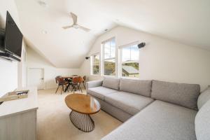 a living room with a couch and a table at Dock Holiday with Carriage House #134 in Chelan