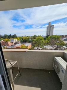 a balcony with a view of a city at Departamento amoblado con balcón y cochera en la entrada de escobar in Belén de Escobar