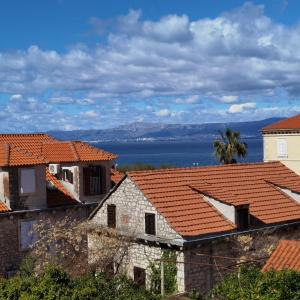 a view of the ocean from the roofs of houses at Apartmani Neva Supetar in Supetar