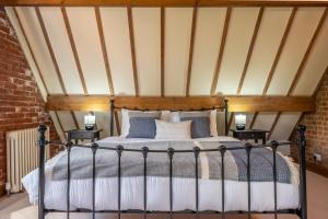 a bedroom with a bed with two night stands at The Cart Shed NC in North Creake