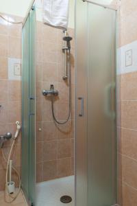 a shower with a glass door in a bathroom at Hostel Pisa Tower in Pisa