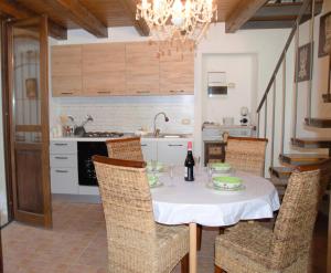 a kitchen with a table with a bottle of wine at A VIUZZA SIRACUSA in Syracuse