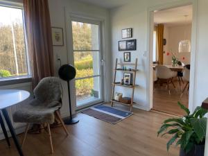 a living room with a table and a chair at Cozy Nature House in Svendborg