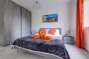 a bedroom with a bed with an orange bow on it at Modern Studio Central Location in Sliema +33 photos