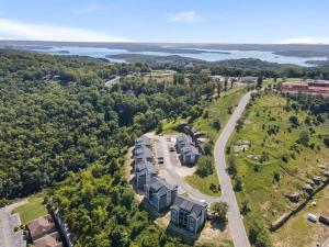 an aerial view of a building with trees and a road at Luxury Modern Condo by the Lake - Breezy Escape in Branson