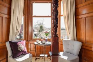 a room with a table and two chairs and a window at Strathallan Bed and Breakfast in Grantown on Spey