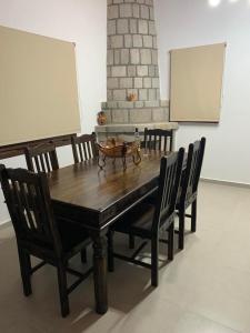 a wooden table with chairs and a white board at Villa Vigla in Zefiría +20 photos