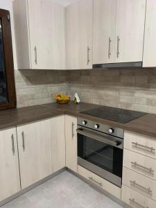 a kitchen with white cabinets and a stove top oven at Villa Vigla in Zefiría