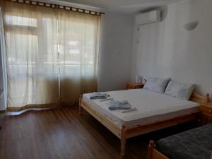 a small bedroom with a bed and a window at Mechta Family Hotel in Obzor +37 photos