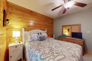 a bedroom with a bed with a wooden wall at Lazy Bear Lodge in Ranger