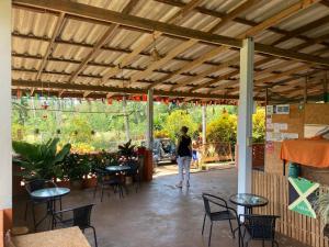 a woman walking through a patio with tables and chairs at Koh Mak Homestay in Ko Mak