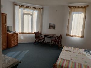 a bedroom with a table and chairs and a bed at Mechta Family Hotel in Obzor