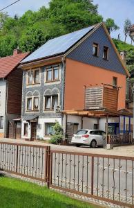 a house with a car parked in front of it at Ferienwohnung Schlothauer 2 in Ruhla