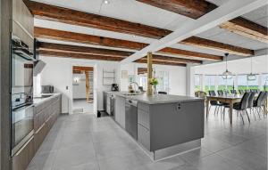 a kitchen with stainless steel appliances and a dining room at Nice Home In Tim With House A Panoramic View in Halkær