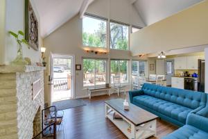 a living room with a blue couch and a fireplace at Prescott A-Frame with Deck - 12 Mi to Lynx Lake! in Prescott