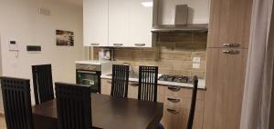 a kitchen with a table and chairs and a stove at RESIDENCE ROTUNDO in Montepaone Lido