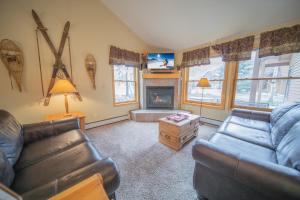 a living room with a couch and a fireplace at Snake River 26 in Keystone