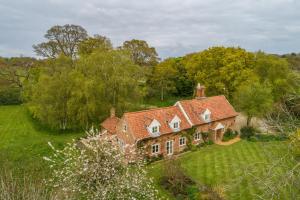 an aerial view of a house in a field at Keepers Cottage Wolterton in Aylsham